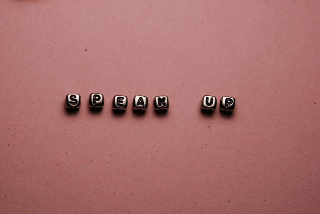 Speak Up Letters on Pink Surface