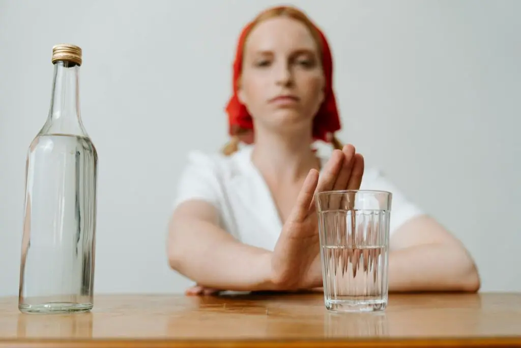 Woman in White Shirt Leaning on Brown Wooden Table