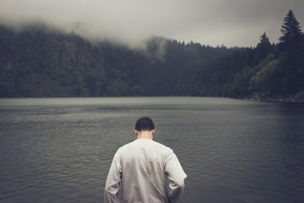 A man standing in front of a body of water