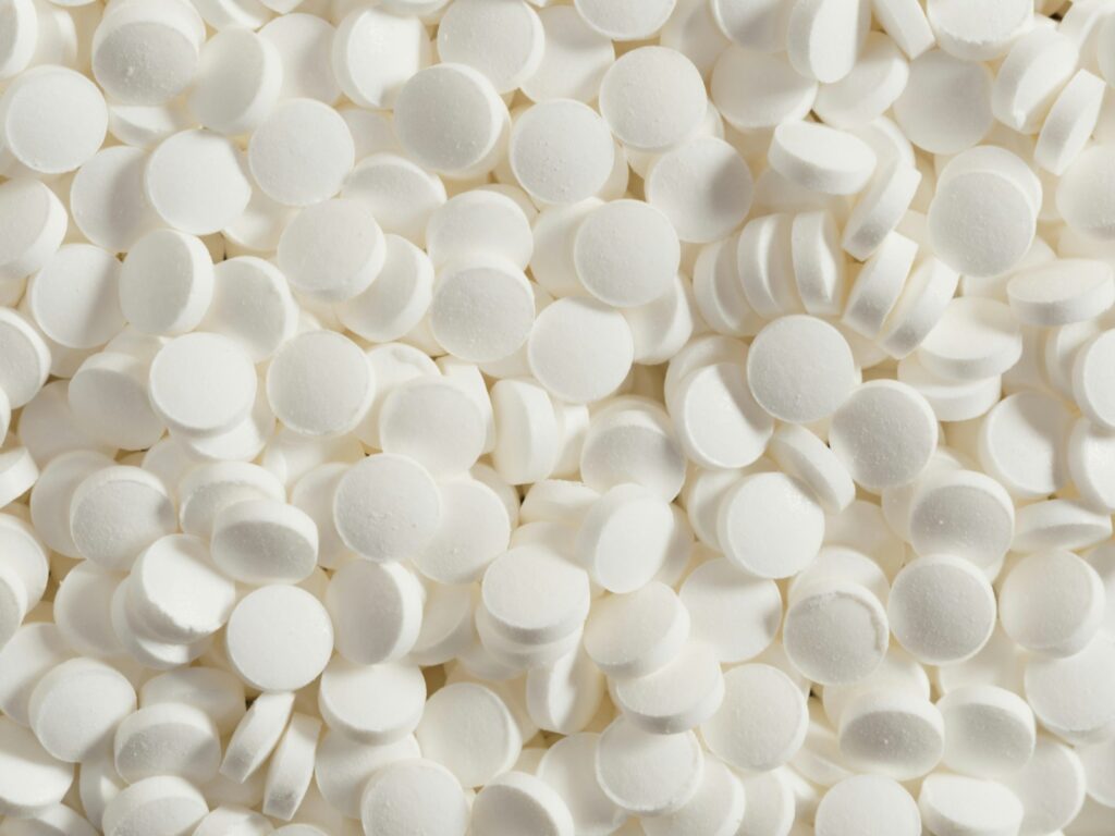 5 Common Medications That Could Be Affecting Your Prostate: What You Need to Know 2 Piles of small, white tablets fill the space.