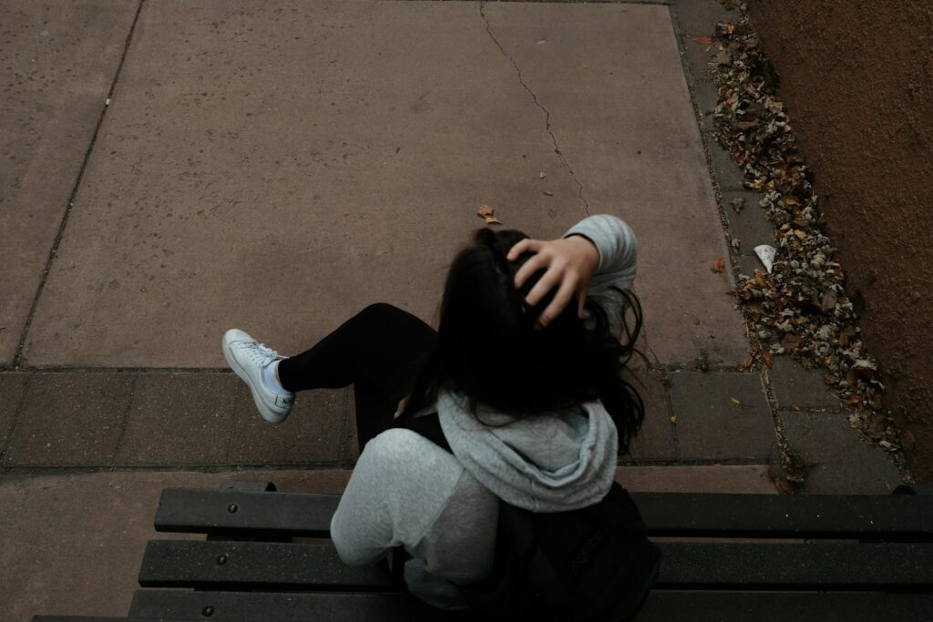 Living with Complex PTSD: How to Handle It and Live a Healthy Life 2 a person sitting on a bench on a sidewalk