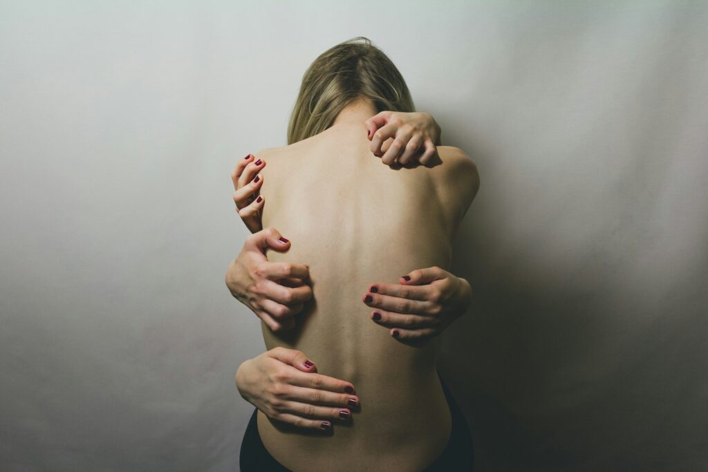 Managing Chronic Pain Means More Than Pills — It Starts with Hearing Your Story 2 woman in black tank top covering her face