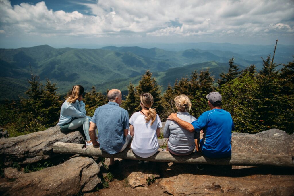 How Our Early Environments Shape Emotional Health for Life 2 group of people sitting on rocks overlooking mountain