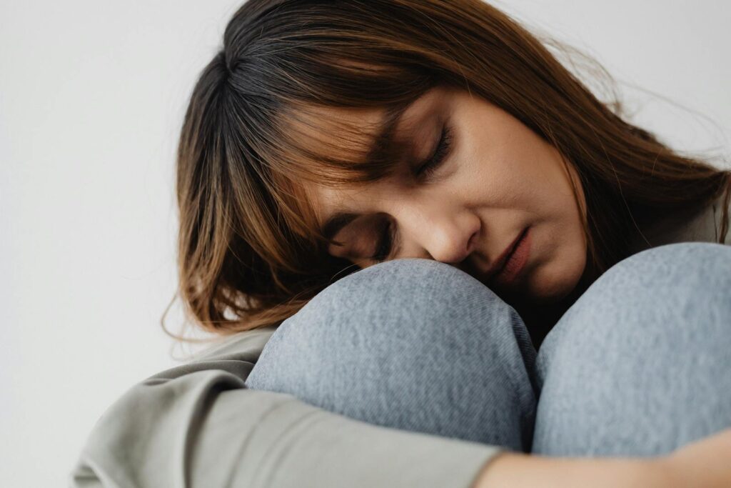 Trauma Might Be the Real Addiction Trigger No One Talks About 2 Serene close-up of a woman resting indoors, eyes closed, conveying peace and relaxation.