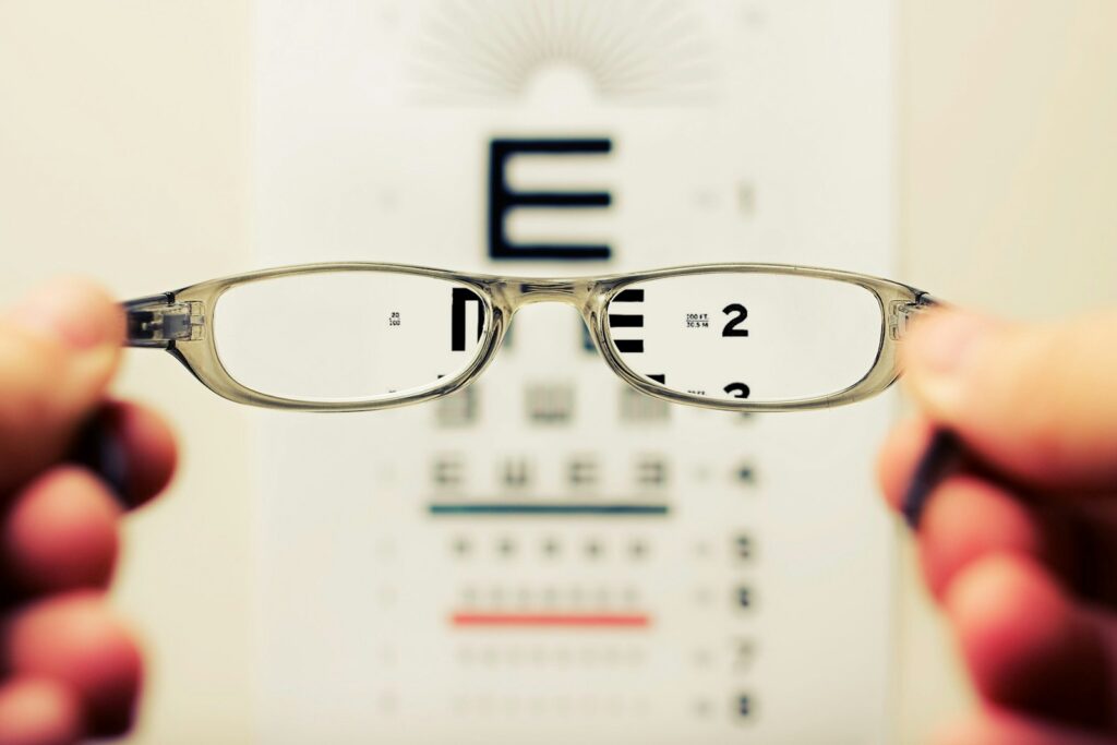 How Home Eye Tests Are Making Eye Care More Accessible in Manchester 2 person holding eyeglasses
