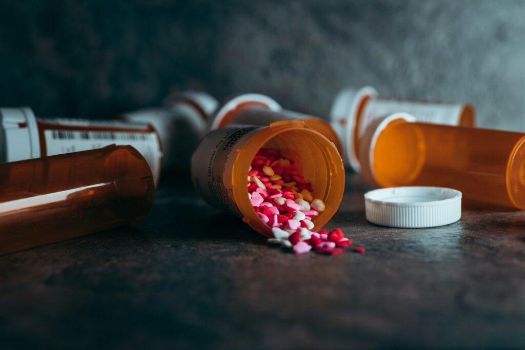 The Addiction Nobody at Work Sees: How People Build Their Entire Day Around Hiding Substance Use 2 a close up of a bottle of pills on a table